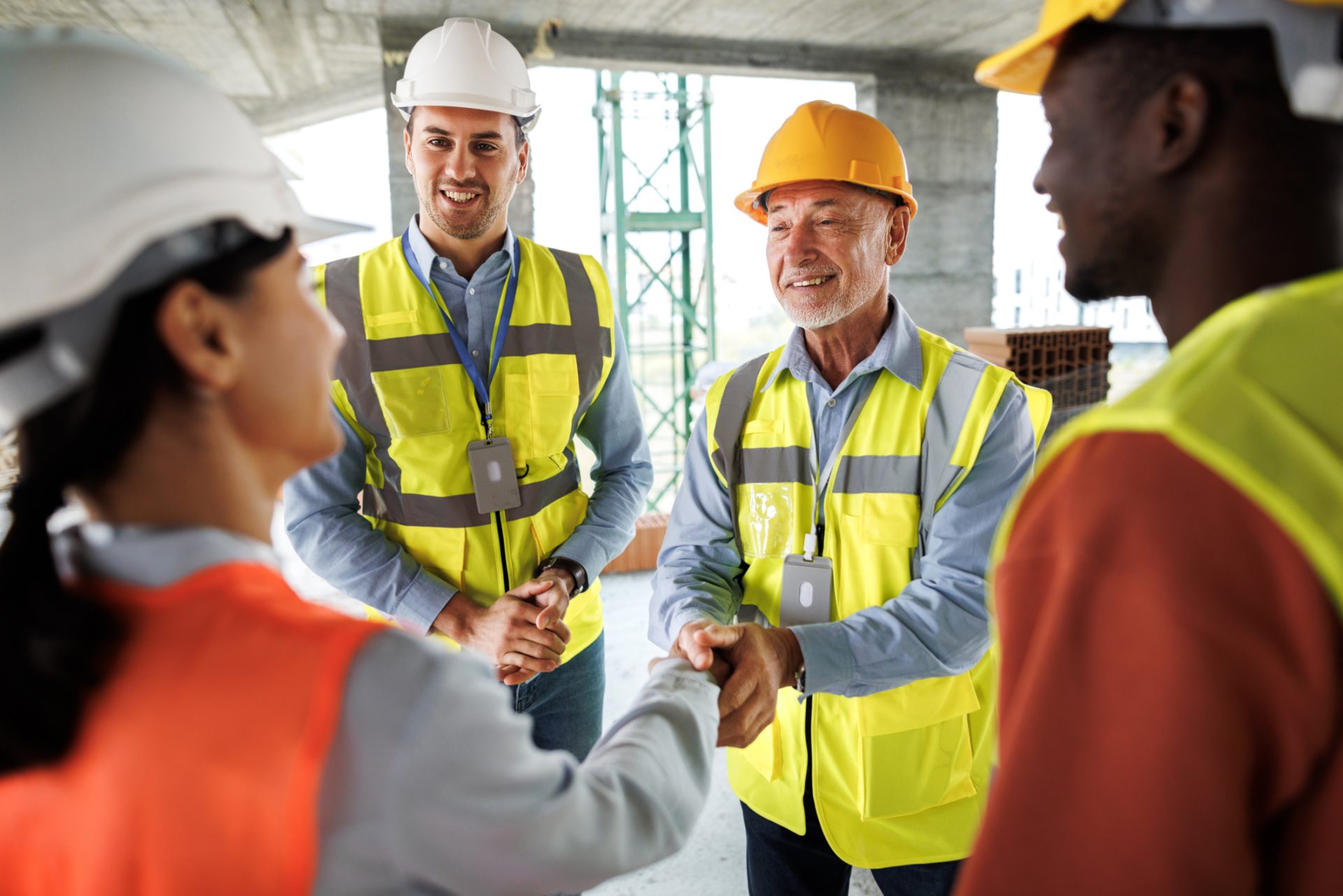 Colleagues shaking hands on a job site