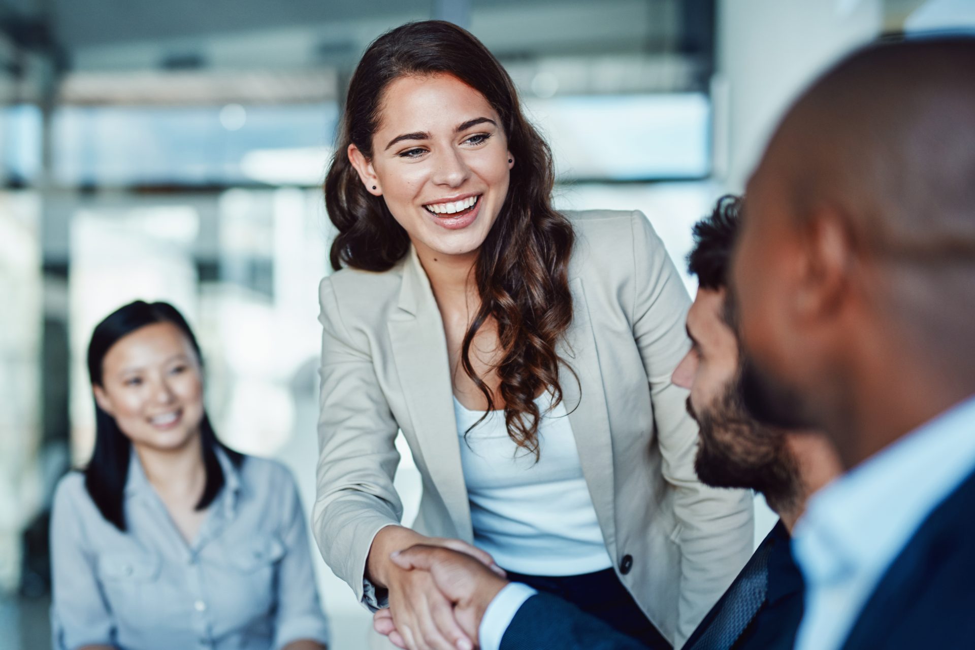 Businesswoman shaking hands with a colleague in a modern office