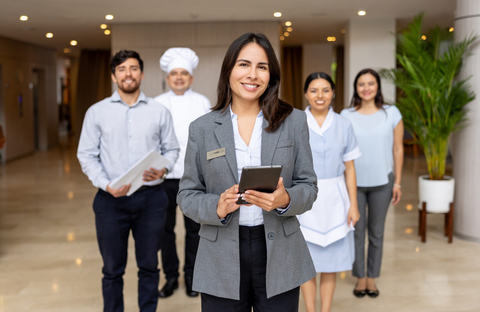 Hotel manager leading a group of employees in the lobby